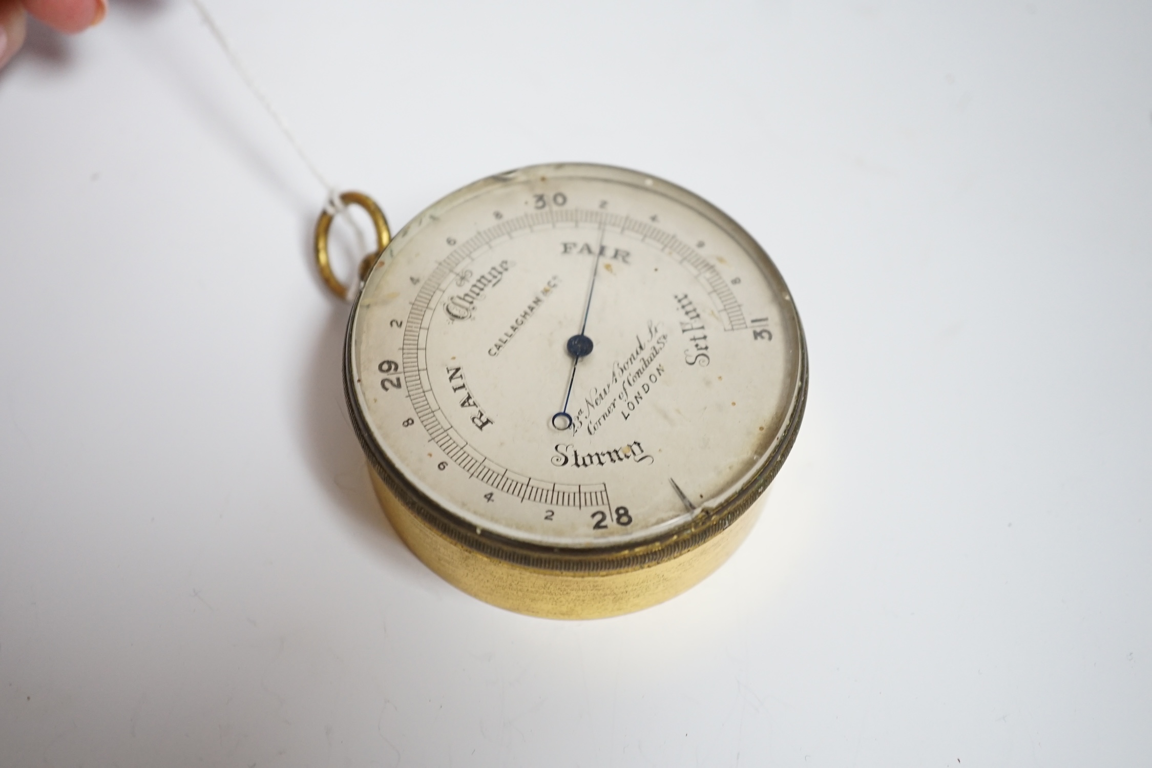 A gilt metal circular pocket barometer by Gallagher and Co., New Bond Street, London (lacks case) and a reproduction solid brass Brunton nautical compass in wooden box